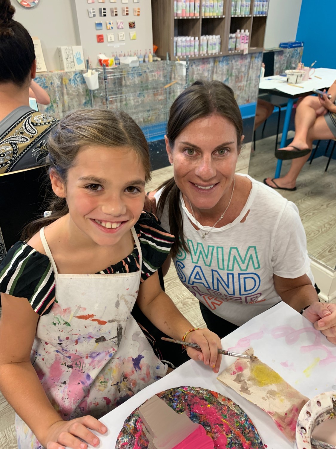 Samara and a young painter creating together at The Painting Place