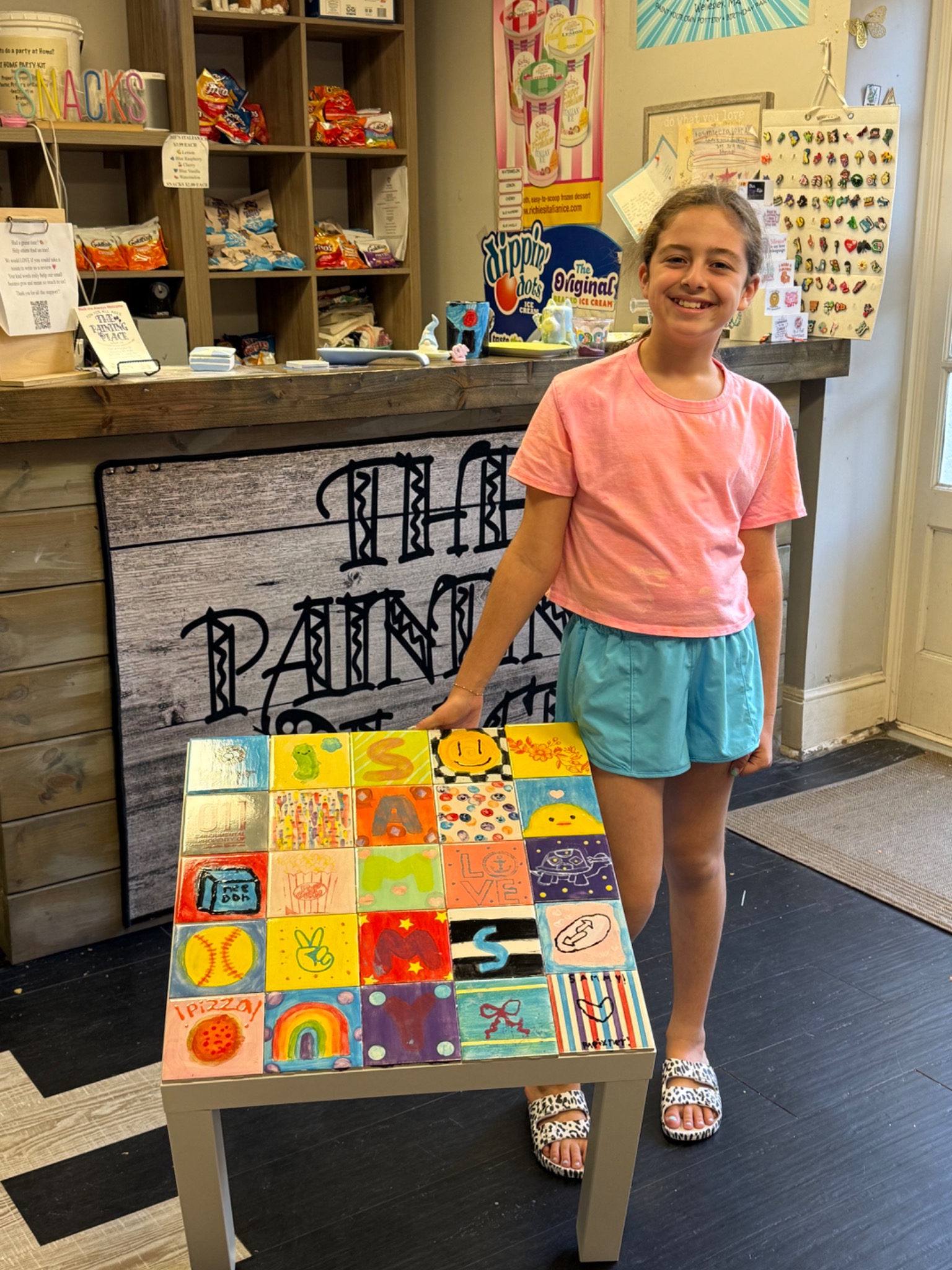 A guest proudly showing a colorful handmade tile table